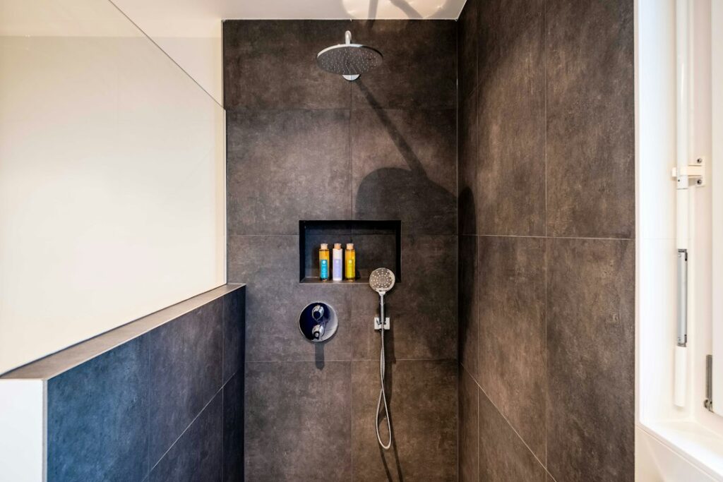 Best Handheld Shower Heads for Seniors: 5 Picks for Seated Showers 1 Walk-in shower with a handheld shower head on a wall holder