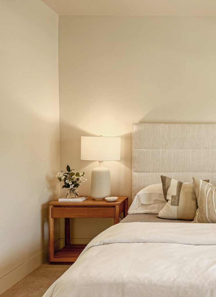 Bedside Step Stool for Seniors: How to Get In and Out of a High Bed Safely 1 Bedroom with a bed, nightstand and lamp, where a bedside step stool can help seniors get in and out of a high bed safely